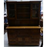 A Ercol Golden Dawn elm Dresser, the upper section with adjustable open shelves flanked by a pair of