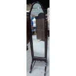 A Cheval Mirror in mahogany frame and on splay supports.