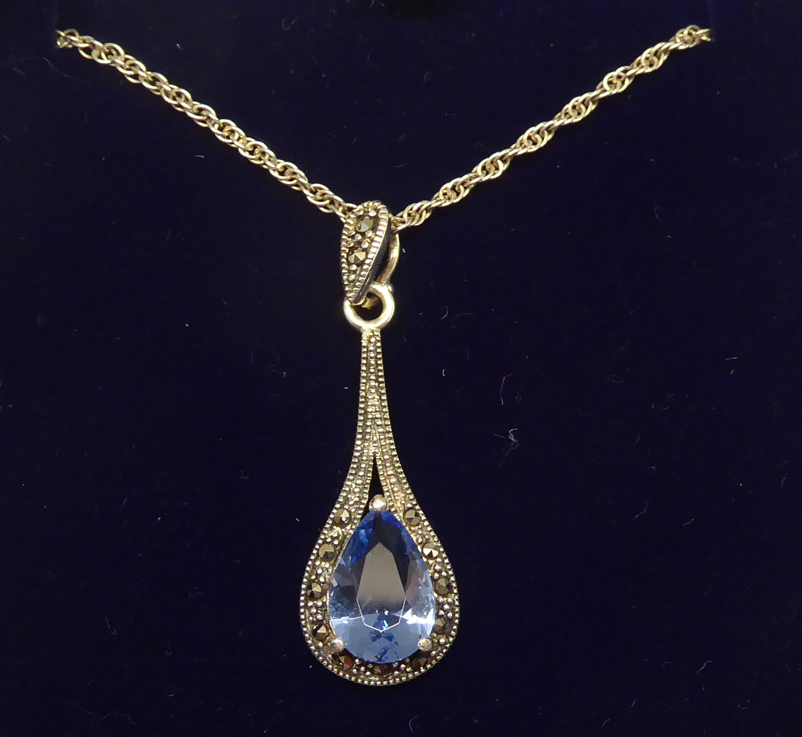 A silver stone set and marcasite Pendant on a fine link neck chain.