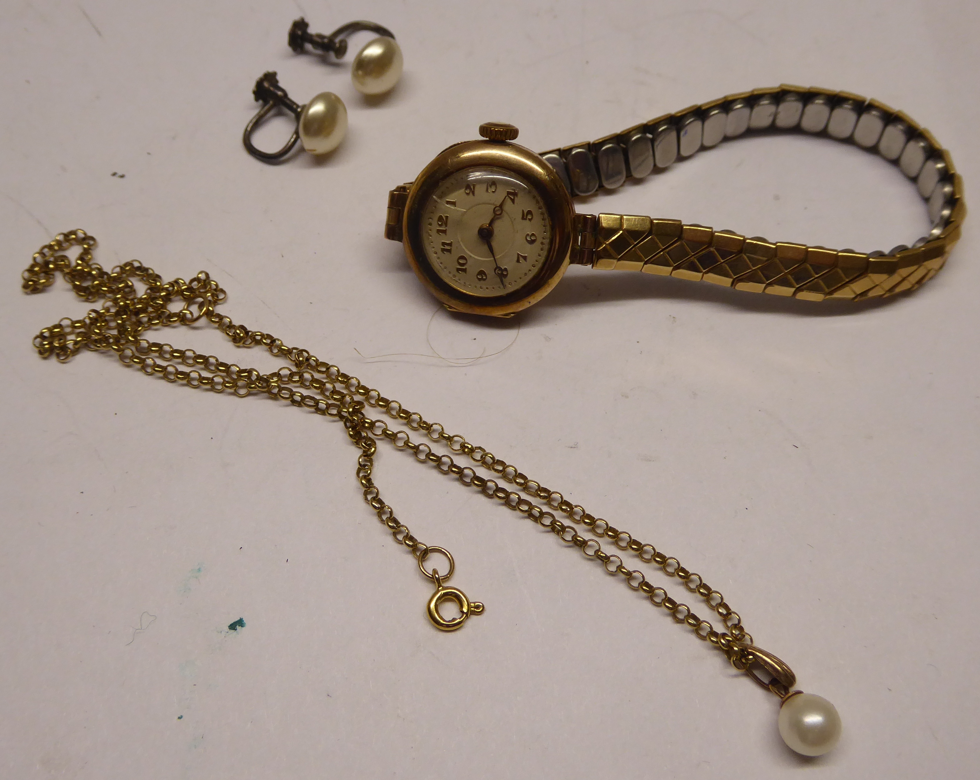 A Lady's Wristwatch with circular dial and Arabic numerals in 9ct. gold case, a 9ct. gold