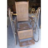 An Invalid Chair by the Gendron Wheel Company, Perrysburg, Ohio, with caned back and seat, flanked