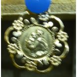 A gold circular Religious Pendant marked "750", 2.8g.