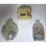 A Chinese carved Ivory model of an elephant, 2" (5cms) long, and two glass snuff bottles.