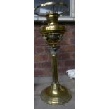 A brass Table Oil Lamp with a Corinthian column and circular foot. 19" (48cms) high.