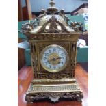 An early 20th century Mantle Clock with white dial and striking movement, in a brass case, with