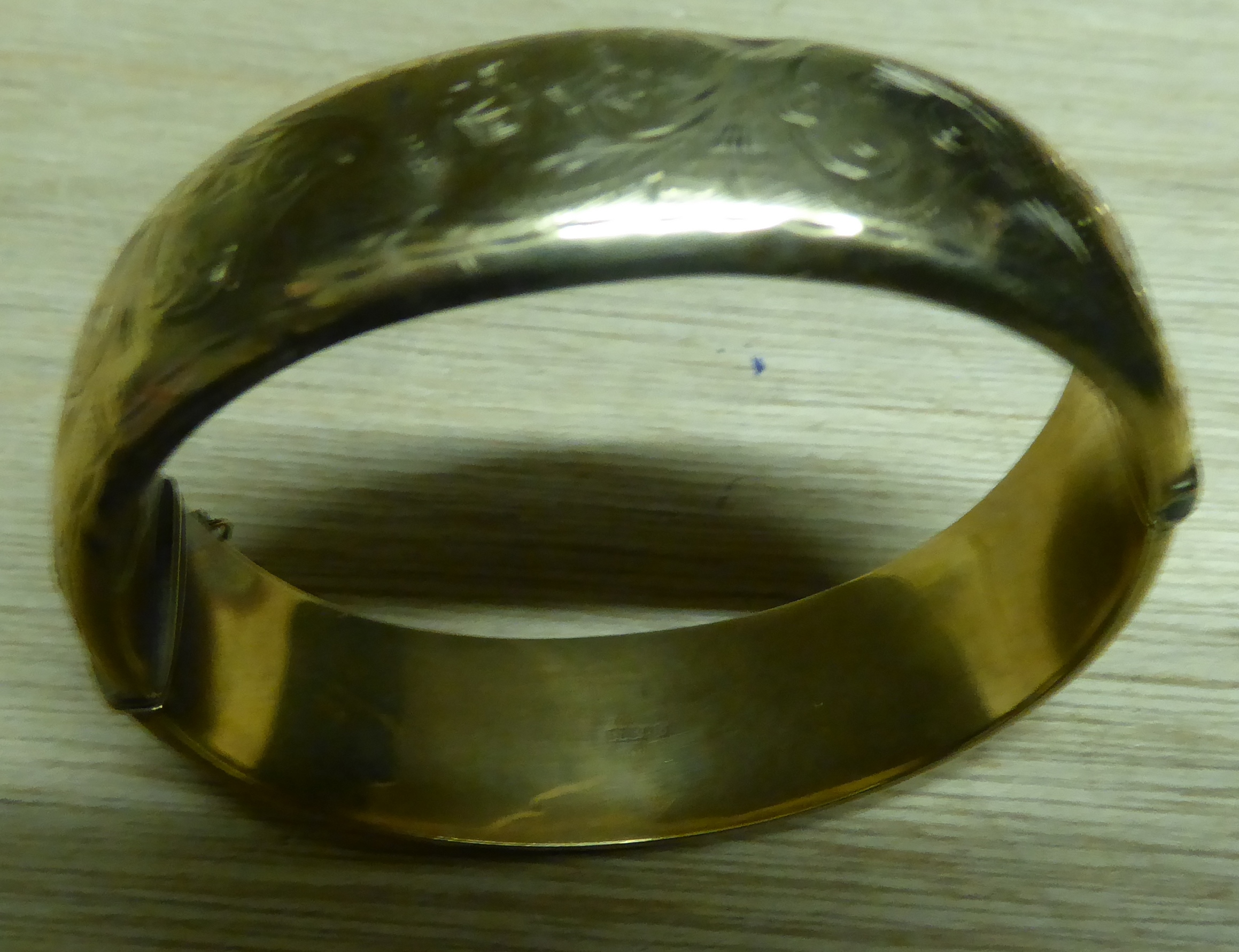 A 9ct engraved gold hollow Bangle, 25.4g.