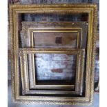 A large gilt wood Picture Frame. 58" (147cms) x 49" (125cms), and two smaller gilt wood frames.