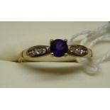 A 9ct. gold Dress Ring with a centre amethyst and the shoulders set with cubic zirconia.