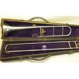 A silver plated Trombone with engraved decoration, cased.