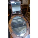 A Victorian Upright Swing Toilet Mirror in mahogany frame and on platform base, and bevel edge