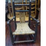 A late Victorian Child's Elbow Chair with rush seat.