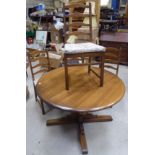 A Ercol Golden Dawn elm circular Dining Table with extension leaf, and a set of four ladder back