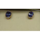 A pair of 9ct. gold Earrings each set with an oval cut tanzanite.