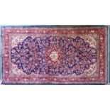 A Hamadan Carpet of all over floral design on a blue field and bordered. 10' 6" (320cms) x 5' 8" (