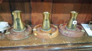 Set of three brass ashtrays