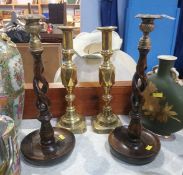 A pair of oak barley twist candlesticks and a set of brass sticks