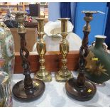 A pair of oak barley twist candlesticks and a set of brass sticks