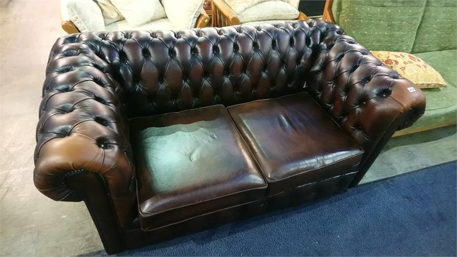 A Chesterfield brown leather settee