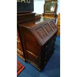 An oak linenfold bureau