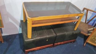 Two footstools and a teak and glass coffee table
