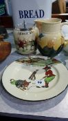 A Royal Doulton Series Ware golfing plate, a Fencing biscuit barrel and a Dickens milk jug (3)
