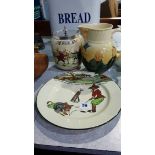 A Royal Doulton Series Ware golfing plate, a Fencing biscuit barrel and a Dickens milk jug (3)