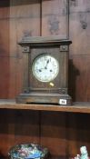 An oak cased mantel clock