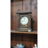 An oak cased mantel clock