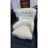 A light green button back armchair