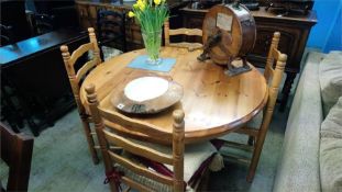 A pine circular table and chairs