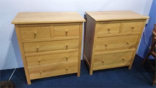 A modern pair of light oak chest of drawers