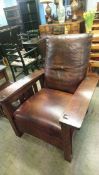 A Stickley of America large oak armchair with brown leather and matching footstool and side table
