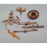 A collection of various gold brooches etc.