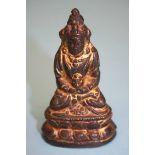 A small gilt bronze Chinese Deity. 8 cm high