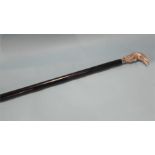 An ebonised walking cane.