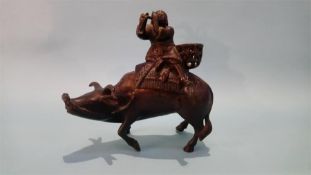 A bronze Oriental figure group of a gentleman riding a water buffalo