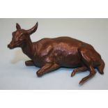 An Oriental fine cast model of a recumbent deer. 5 cm high