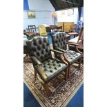 A pair of green buttoned back leather Chesterfield carver chairs