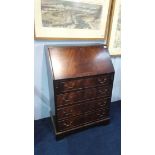 A reproduction mahogany bureau