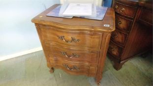 A pair of American bedside chest of drawers, 60cm wide