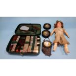 An Armand Marseille doll, two miniatures, a purse and a vanity kit