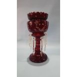 A cranberry glass table lustre.