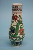 A slender Chinese porcelain vase, decorated with dragons amongst foliage (with glass plates). 20.5