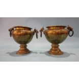 A pair of ornate Middle Eastern brass vases, with ring handles.