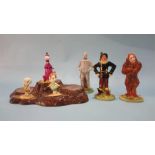 Three Beswick Flintstone figures, three Royal Doulton Wizard of Oz figures and a stand.