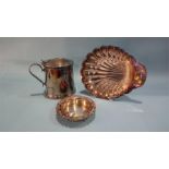 A large silver plated tankard, a wine coaster and a shell dish.