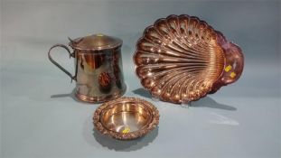 A large silver plated tankard, a wine coaster and a shell dish.