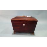 A Georgian mahogany sarcophagus shaped tea caddy.