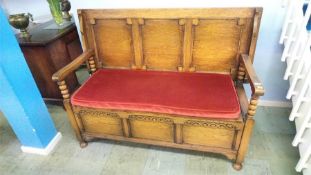 An oak monks bench with panelled back, 137cm wide