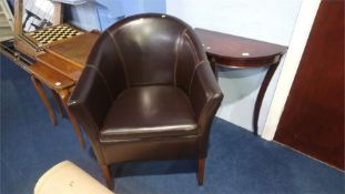 A half moon table and a brown tub chair
